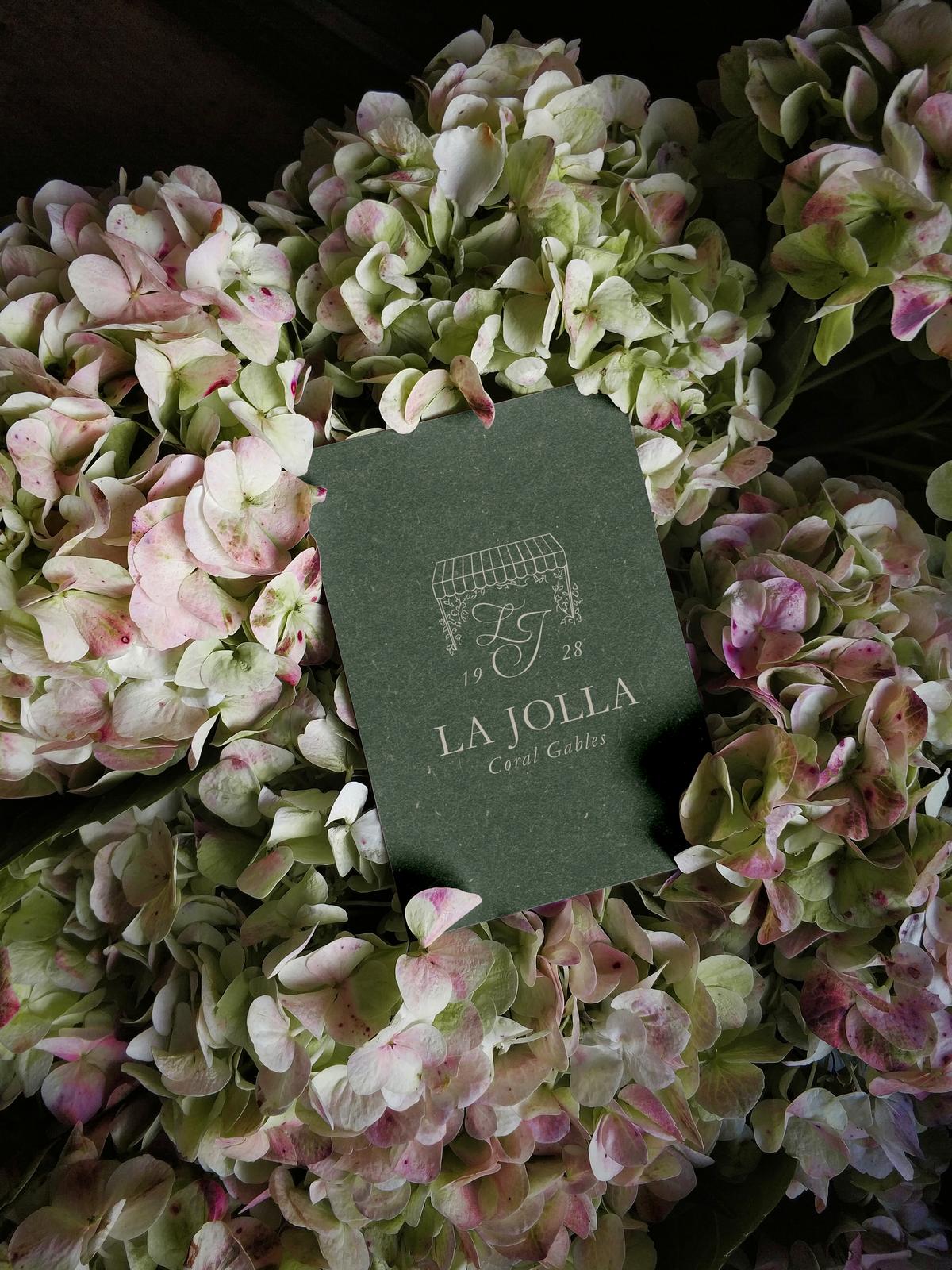 La Jolla card among flowers.